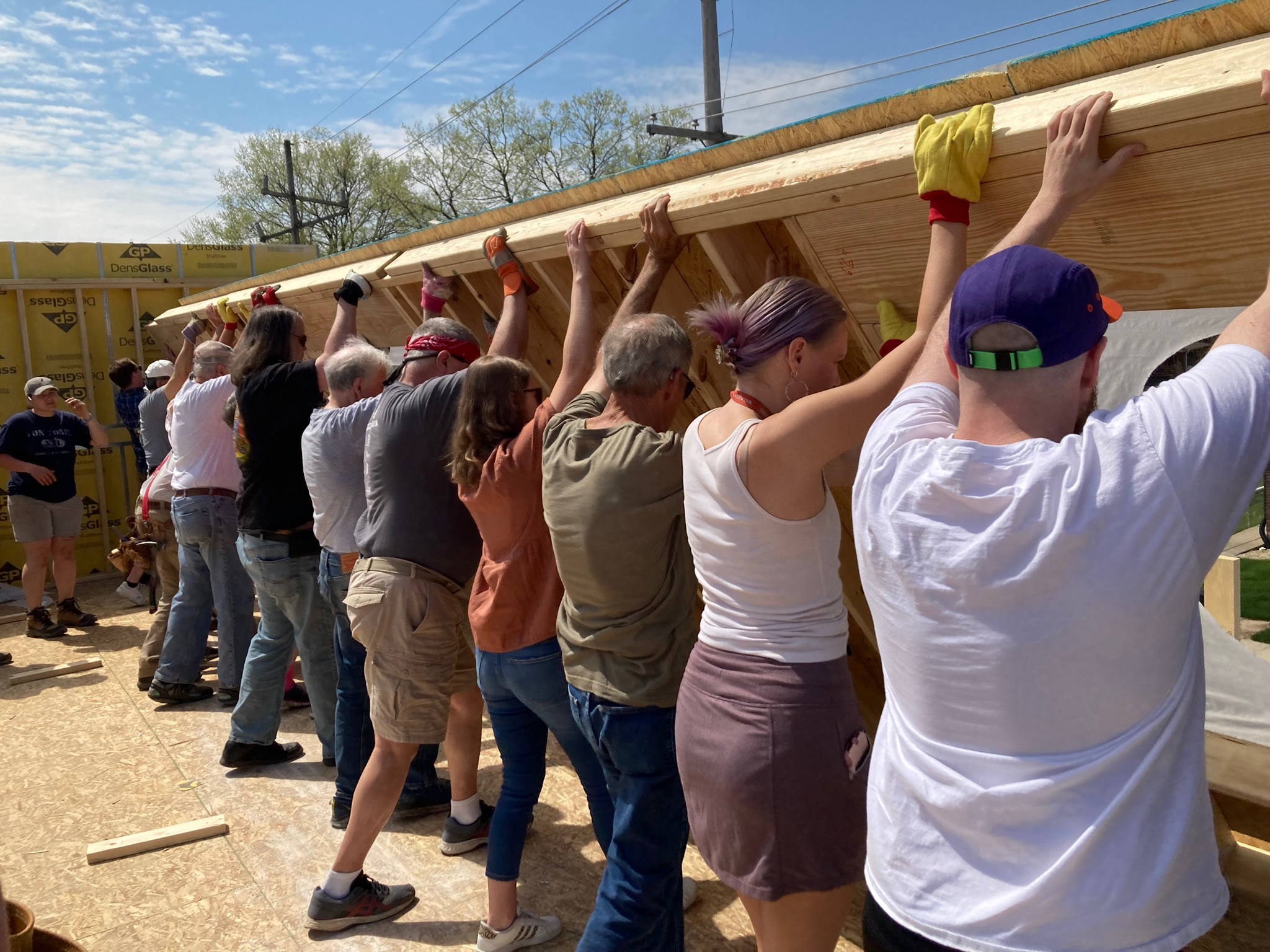 IMG_2706 Volunteers lifting up a wall for Project Neighbors volunteer project